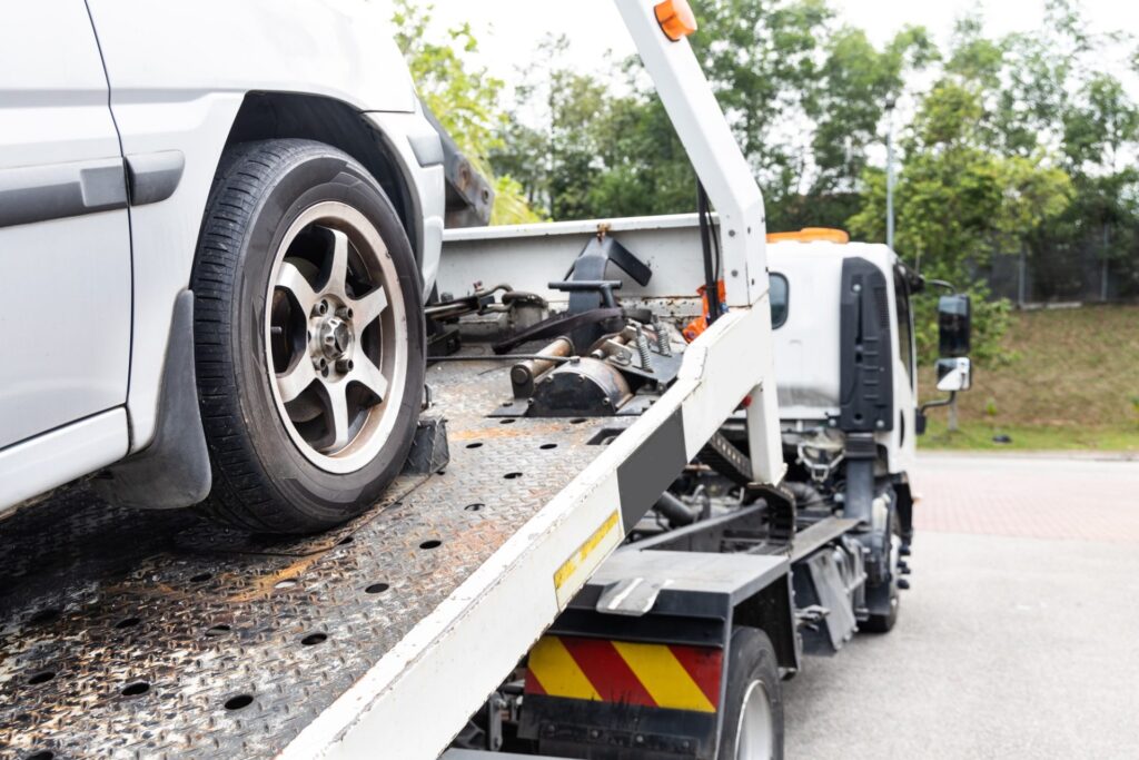 cable-attached-to-broken-down-car-being-pulled-onto-tow-truck-e1632202724823.jpg